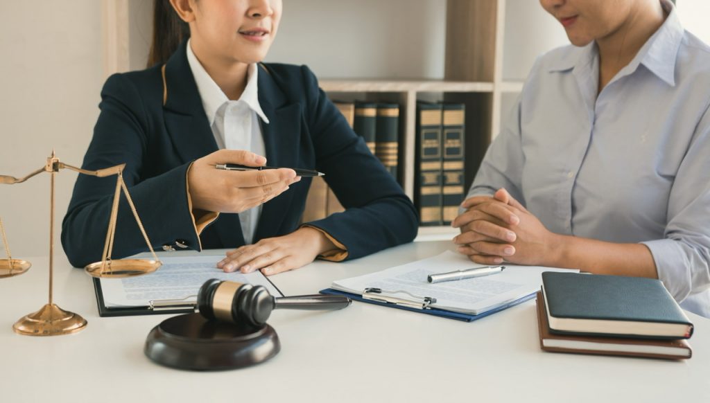 Woman judge is currently advising clients on their requests for legal proceedings and legal advice. By wutzkoh