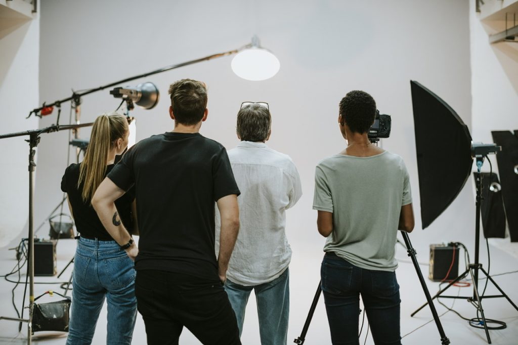 Production team working together in a studio By Rawpixel