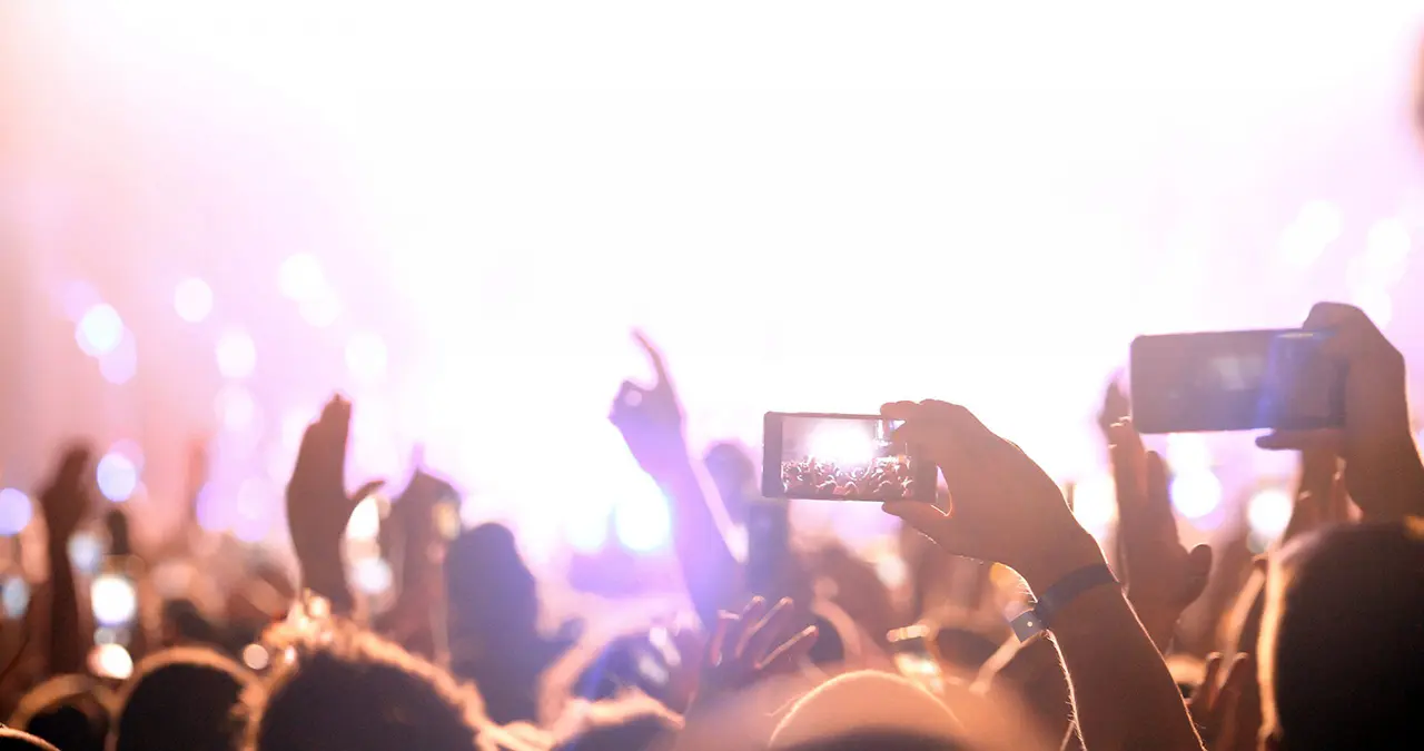 Fan taking photo of concert at festival By nd3000