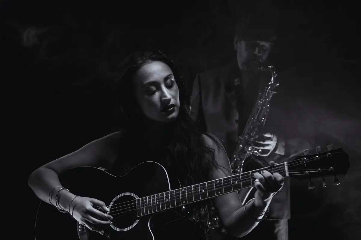 Launch music on TikTok by creating engaging content, like this moody black-and-white duo performing guitar and saxophone.