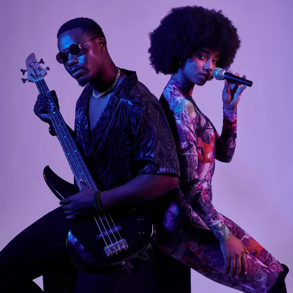 Music promotion strategies include strong visuals, as shown by a stylish duo with a bass guitar and microphone in a vibrant setting.