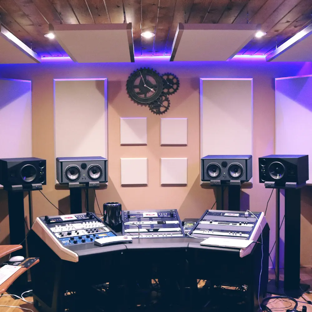 Music social media platforms with a professional home studio setup featuring acoustic panels and high-end audio gear
