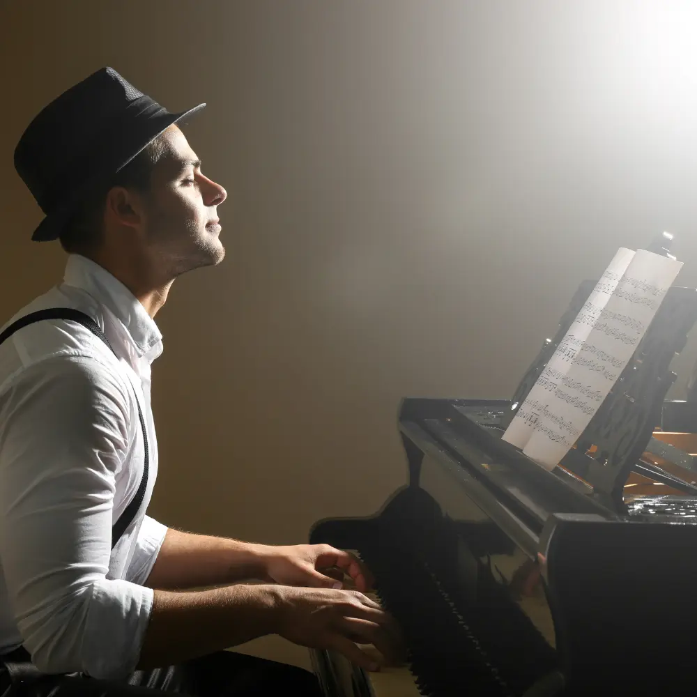 Viral music content idea featuring a stylish man emotionally playing piano with sheet music in soft lighting.