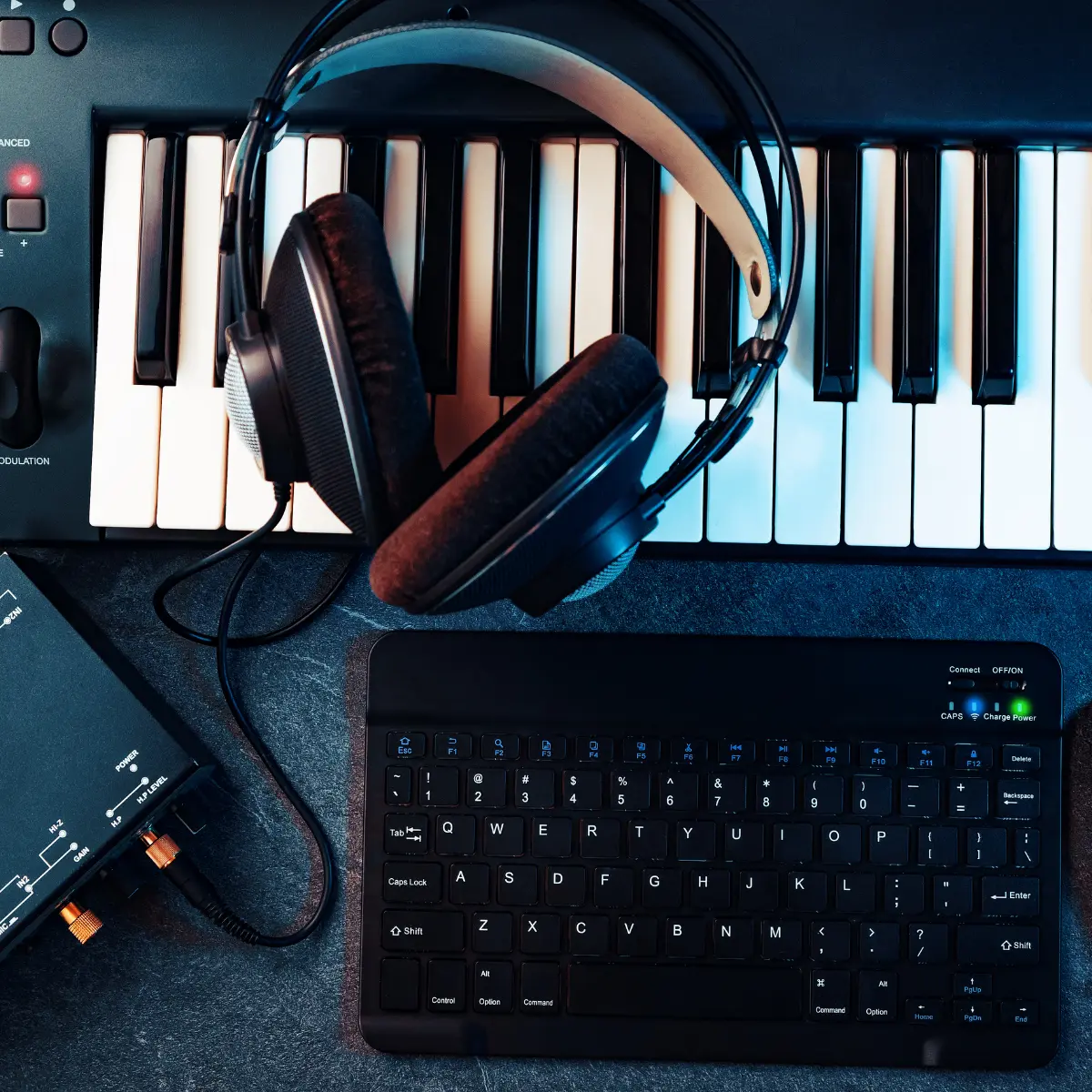 Music portfolio production setup featuring keyboard, headphones, and MIDI interface.